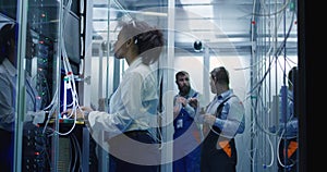 Women working with cables in data center