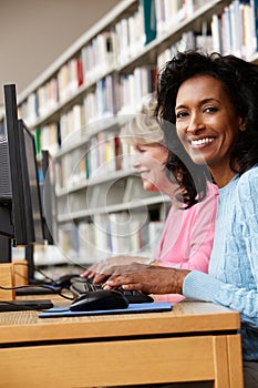 Women working on computers in library