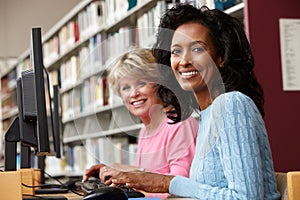 Women working on computers in library