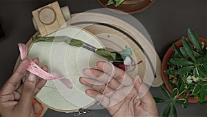 Women working with Embroidery Floss threads and wooden stand hoop