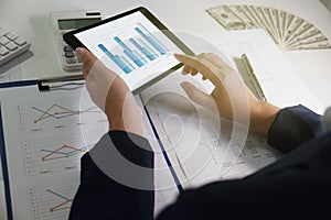 Women working in office. financial analysis with charts on tablet for business, accounting, insurance or finance concept