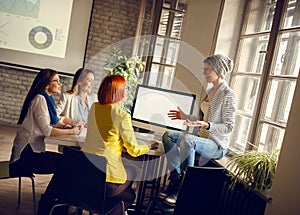 Women at workplace presents ideas for business photo