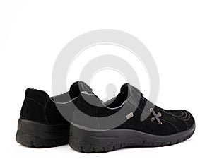 Women's black hiking boots isolated white background. Back side view. Fashion shoes. Photoshoot for shoe shop concept.