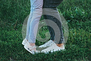 Womens and child shoes  outdoors. Lifestyle photo of womens casual shoes on the grass