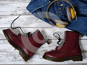 Womens clothing, accessories, footwear burgundy boots, yellow wireless headphones, denim jacket. Fashion outfit. Shopping