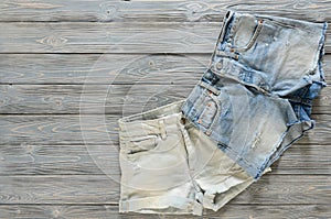 Womens clothing denim shorts on grey wooden background with co