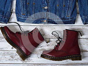 Womens clothing, footwear burgundy boots, denim jacket. Fashion outfit. Shopping concept. Flat lay