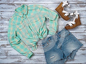 Womens clothing, shoes plaid shirt, denim shorts, wedge sandals. Fashion outfit, spring summer collection. Shopping concept.