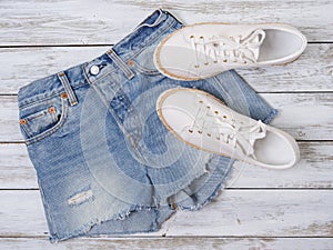 Womens clothing, shoes white sneakers, denim shorts. Fashion outfit, spring summer collection. Shopping concept. Flat lay, view