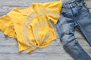 Womens clothing yellow blouse in polka dot, blue jeans. Fashio