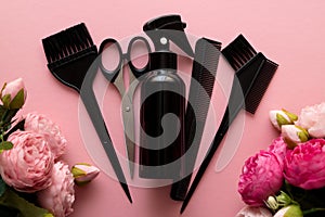 Womens day, layout of hairdressing tools on pink background with flowers, flat lay, top view