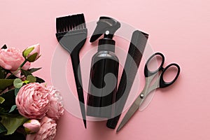 Womens day, layout of hairdressing tools on pink background with flowers, flat lay, top view