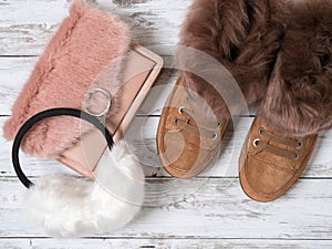 Womens fashion accessories, shoes suede sneakers, crossbody bag, white fur earmuffs. Shopping concept. Flat lay. Winter