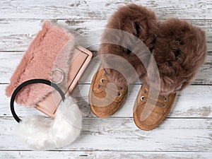 Womens fashion accessories, shoes suede sneakers, crossbody bag, white fur earmuffs. Shopping concept. Flat lay. Winter