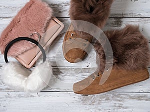 Womens fashion accessories, shoes suede sneakers, crossbody bag, white fur earmuffs. Shopping concept. Flat lay. Winter