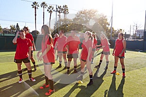 Womens Football Team Training For Soccer Match On Outdoor Astro Turf Pitch