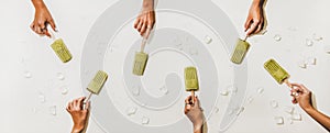 Womens hands with green matcha coconut popsicles over white background