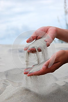 Womens hands with sand