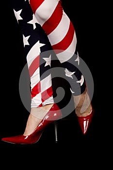 Womens legs wearing flag leggings and red high heels