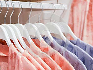 Womens pajamas hang on store hangers. Selling womens pajamas in the market. Advertising, sale, fashion concept. Dresses in a row