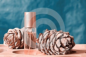 Womens perfume bottle on the display with natural cones