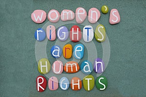 Womens rights are human rights, feminist slogan composed with multi colored stone letters