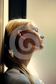 Womens secrets. Woman with blond hair ponytail relax at window, daydream. Dream, daydream, meditation. Wellness and