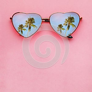 Womens sunglasses on a pink background with space for text