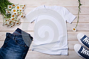 Womens T-shirt mockup with daisy flowers and jeans