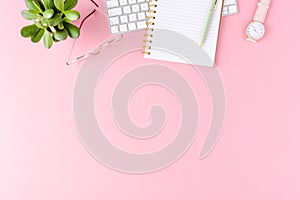 Womenâ€™s desktop with fashion accessories on pink background