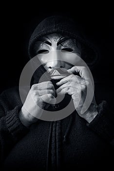 Womman wearing Vendetta mask. This mask is a well-known symbol for the online hacktivist group Anonymous