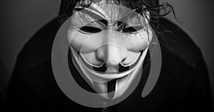 Womman wearing Vendetta mask. This mask is a well-known symbol for the online hacktivist group Anonymous