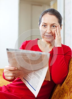 Wonder grief woman with newspaper