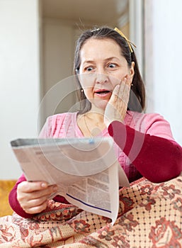 Wonder mature woman with newspaper