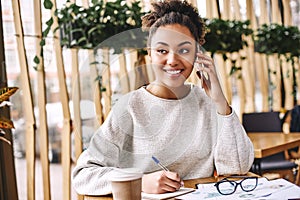 Wonder what your customer really wants? Ask. Donâ€™t tell. Attractive business woman working at desk in modern office.