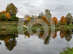 Wonderful autumn landscape with gorgeous and colorful trees by the water, beautiful reflections