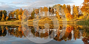 Wonderful autumn landscape with gorgeous and colorful trees by the water, beautiful reflections