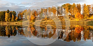 Wonderful autumn landscape with gorgeous and colorful trees by the water, beautiful reflections