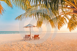 Wonderful beach scenery. Chairs on the sandy beach near the sea, romantic couple and honeymoon