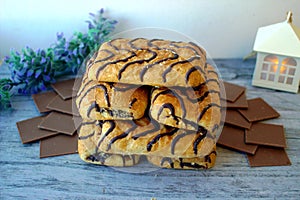 Wonderful biscuit cakes poured with chocolate stand on background