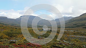 Wonderful bottomland between mountains in Iceland, red, yellow and green grass in cloudy fall day