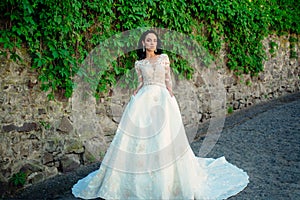 Wonderful bridal gown. Beautiful wedding dresses in boutique. Elegant wedding salon is waiting for bride. woman is