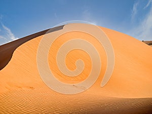 Wonderful desert dune with sun colors