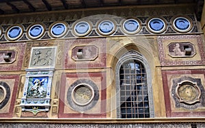 Wonderful element, of a richly decorated wall, with a window on the right side and in the other a colored coat of arms, at villa S