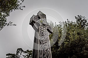 Wonderful embossed Celtic stone cross, full of details and textures in its elaborate carvings and lichen growing