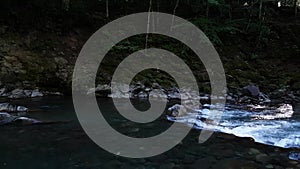 Wonderful fresh river water with rapids on flowing in mountain forest