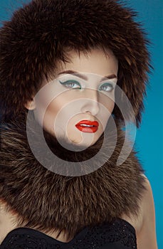 Wonderful girl in a fur hat and scurf photo