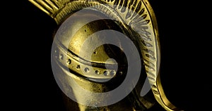 A wonderful golden spartan helmet as part of the equipment of ancient Greek soldiers