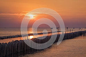 Wonderful golden sunset view on ocean at coastline, dramatic lighting