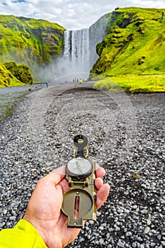 Wonderful, high and huge Skogarfoss waterfall and compass in han